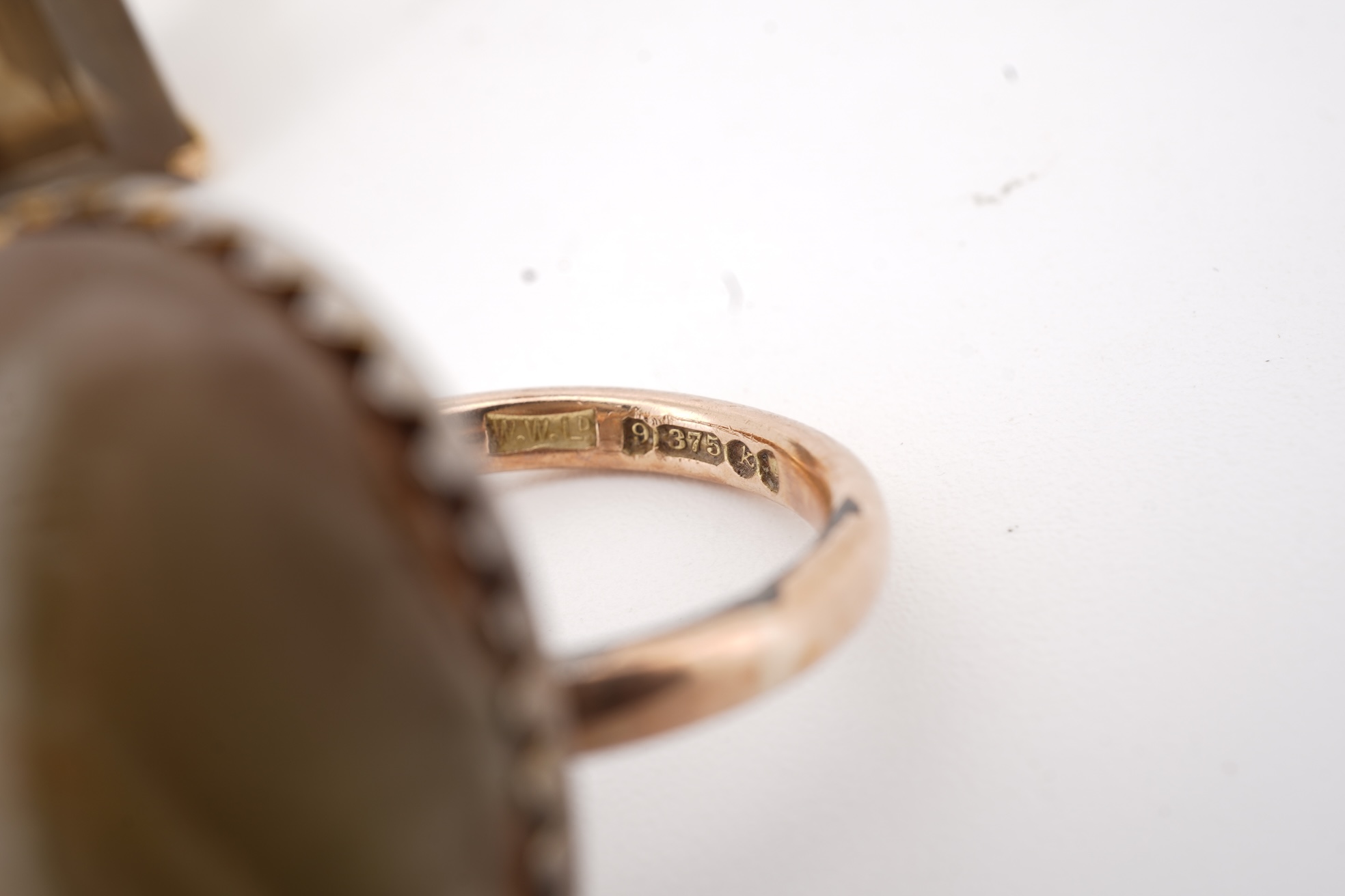 A modern 9ct gold and single stone emerald cut smoky quartz set ring, size N and one other 1960's 9ct gold shank, with a later added agate set white metal mount.